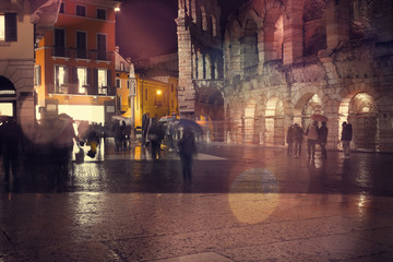 Fototapeta na wymiar Old European illuminated city at rainy night