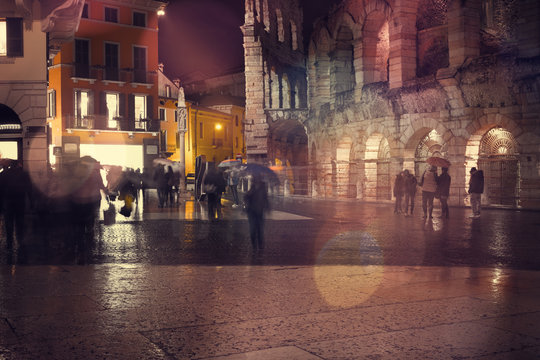 Old European illuminated city at rainy night