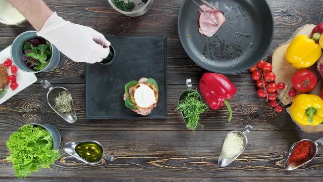 Food ingredients on wooden background. Hand of chef, tasty dish.