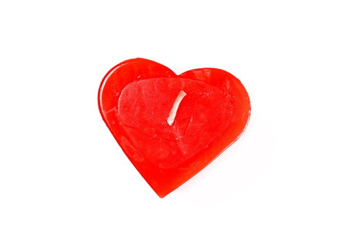 Extinguished red candle in shape of heart isolated on white background, top view