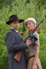 Two models get dressed up in 1930's style  vintage fashion clothes and act the role of  the...