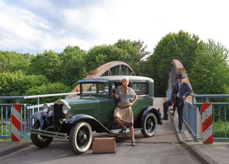 Two models get dressed up in 1930's style  vintage fashion clothes and act the role of  the gangster duo Bonnie and Clyde.