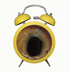 There is a yellow alarm clock with coffee. White background.