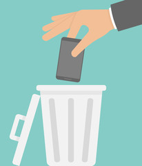 Throwing away a smartphone concept. Hand putting phone into the trash 