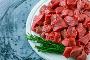 Beef, diced on a patch with rosemary