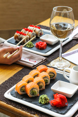 Uramaki rolls with a glass of white wine - restaurant serve