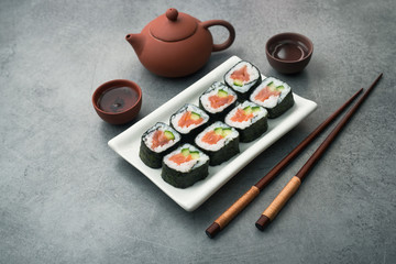 Tea ceremony with sushi salmon and cucumbe