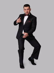 Full length portrait of a handsome guy in tuxedo