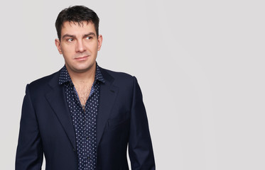 Fototapeta premium smirking handsome man wearing suit