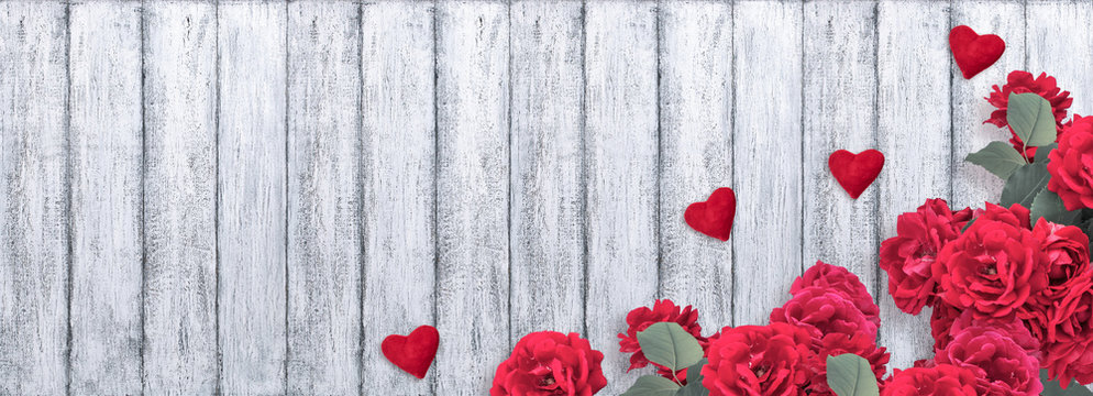 Banner with red roses, Valentine hearts and place for your text on background of shabby wooden planks