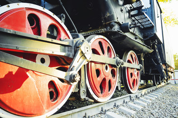 Train drive mechanism and red wheels of an old soviet steam locomotive.