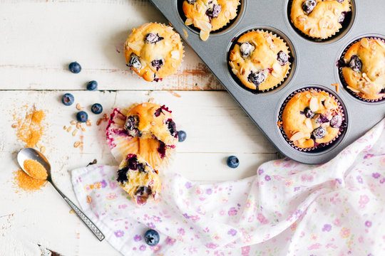 Freshly baked blueberry muffins on a white rustic table