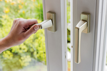 woman opens window to air