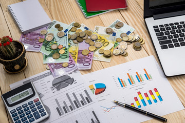 Fototapeta na wymiar Business chart with euro, laptop and calculator on desk