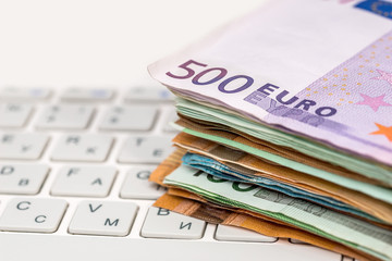 euro bilsl on white keyboard  laptop, close up