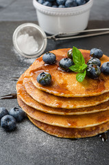 Stack of pancakes with fresh blueberry and caramel syrup
