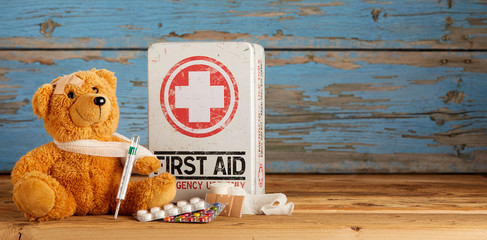 Cute little teddy bear receiving First Aid