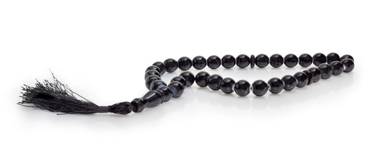 Black prayer beads closeup on a white background