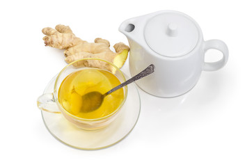 Tea with ginger in glass cup, ginger root, teapot