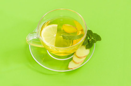Tea with ginger, mint and lemon in glass cup