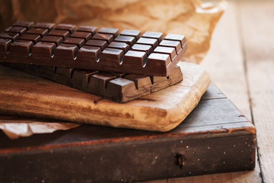 Dark chocolate bar in cutting board