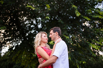 Fototapeta premium A loving couple hugs and walks in the park.