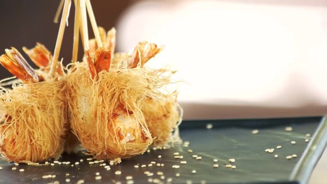 Shrimp tempura close up. Fried prawns, kataifi dough.