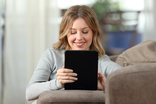 Blonde using a tablet in an apartment interior