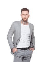Fototapeta premium young tattooed businessman in grey suit, isolated on white