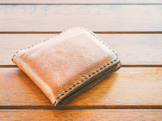 Brown wallet on wood table