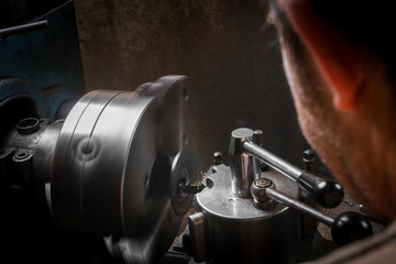 Metal worker working on lathe
