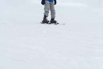 Fototapeta na wymiar Skiers and snowboarders riding on a ski slope