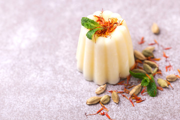 Fototapeta na wymiar Indian kulfi dessert, ice cream with safron, mint, nuts