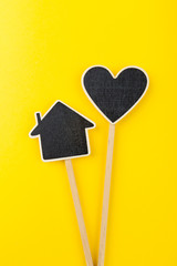 Black chalkboard heart and house on a wooden stick. Mothers day background