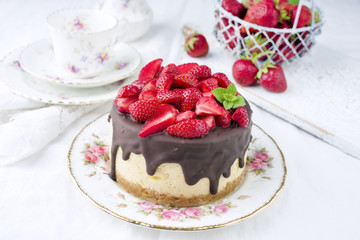 Traditional chocolate strawberry cheesecake with fresh strawberries as top view on a plate