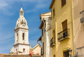 Fototapeta premium Tower of the Santa Maria church and colorful houses in Xativa