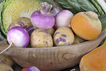 close on turnips  and potatoes on a wooden bowl