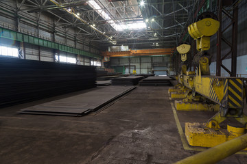 Overhead crane with magnetic lift in the shop for manufacturing large diameter pipes
