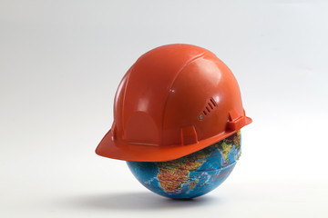 Construction helmet on the globe
