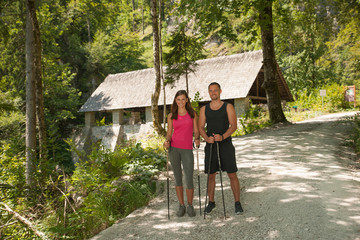 Fototapeta premium Active young couple on a hike in forest on a hot wummer day