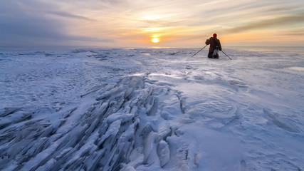 ice desert sunrise on a lake / man photographs the dawn of natural krastata
