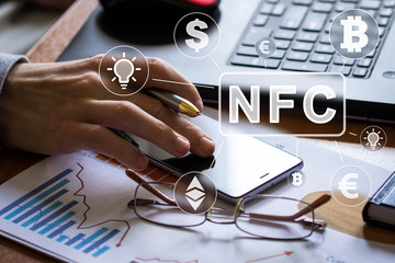 Businessman presses button NFC technology currency idea on phone virtual electronic user interface