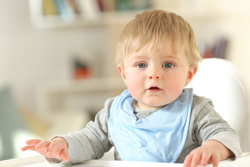 Fototapeta premium Front view portrait of a baby looking at camera