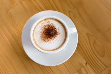 Coffee in a white cup on the table.