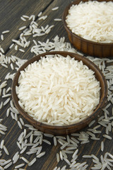 Raw white Basmati rice paddy in small wooden bowls