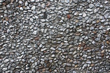 Pebble wall texture background painted with metallic gray paint.
