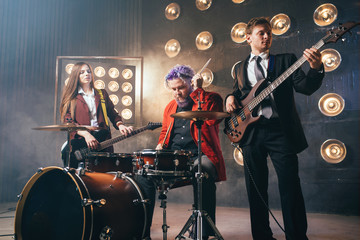 Bearded drummer in red suit, vintage style