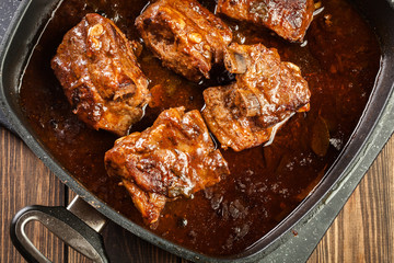 Pork spare ribs on dish in own sauce