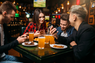 Fun friends in a sport bar, victory celebration