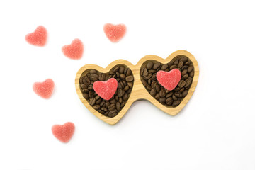 wooden plate with heart candies for St. Valentine's Day and coffee beans, top view